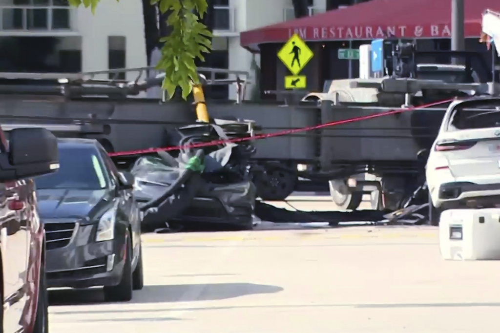 This image taken from a WSVN video shows a crushed vehicle after a crane collapsed at a Miami construction site Monday, Sept. 14, 2026. (WSVN via AP)