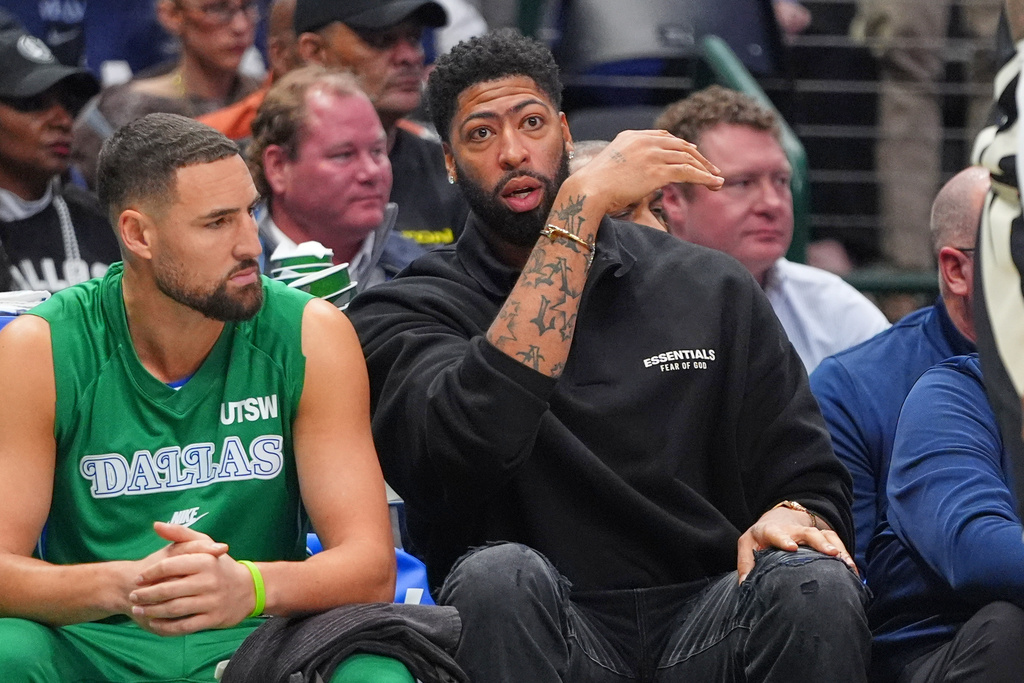 Dallas Mavericks forward Anthony Davis, right, sits on the bench with teammate Dallas Klay Thompson during the first half of an NBA basketball game against the Milwaukee Bucks in Dallas, Monday, Nov. 10, 2025. (AP Photo/LM Otero)