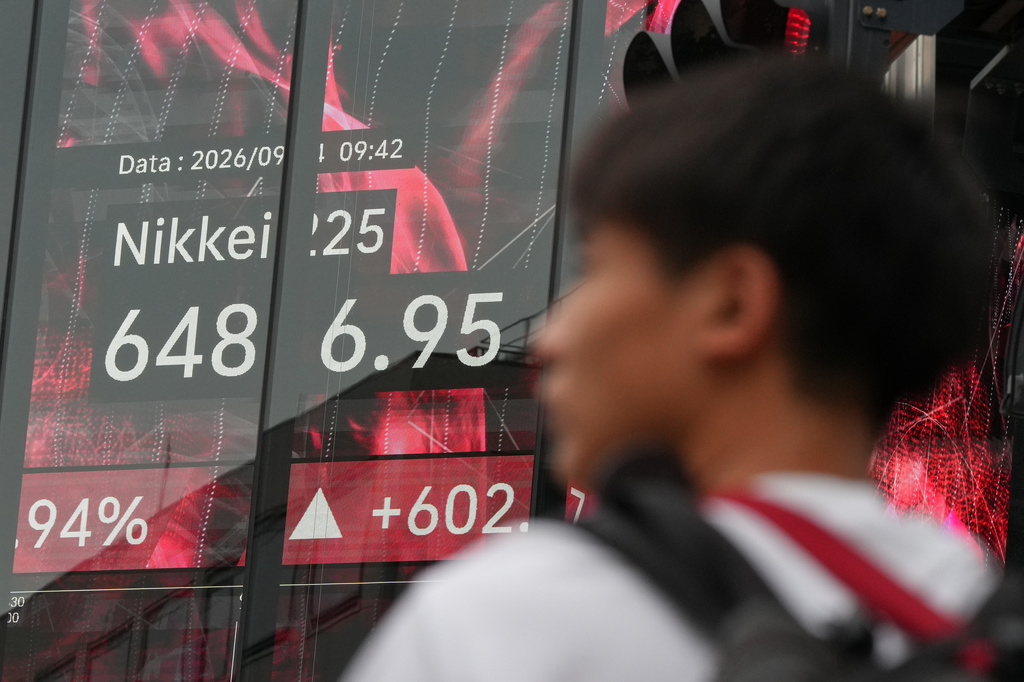 A person stands in front of an electronic stock board showing Japan's Nikkei index at a securities firm Friday, Sept. 4, 2026, in Tokyo. (AP Photo/Eugene Hoshiko)