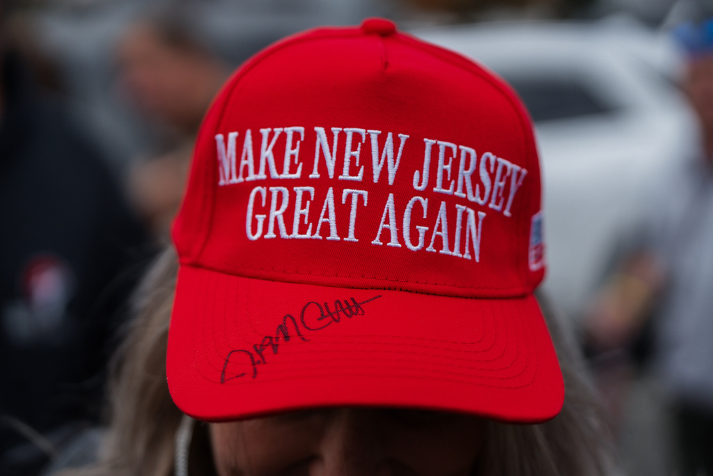 A supporter of New Jersey gubernatorial candidate Jack Ciattarelli wears a "Make Jersey Great Again" hat he signed during a rally on Saturday, Nov 1, 2025, in Westfield, N.J. (AP Photo/Olga Fedorova)
