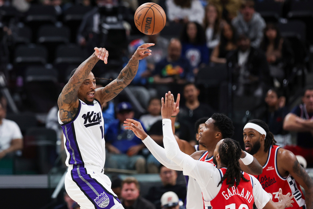 Sacramento Kings guard DeMar DeRozan, left, passes the ball against Los Angeles Clippers guard Darius Garland, front center, and guard Bennedict Mathurin, back center, as forward Isaiah Jackson, back right, watches during the second half of an NBA basketball game, Saturday, March 14, 2026, in Inglewood, Calif. (AP Photo/Jessie Alcheh)