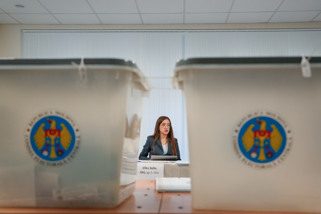 An election official attends to a voting station during a parliamentary election, in Chisinau, Moldova, Sunday, Sept. 28, 2025. (AP Photo/Vadim Ghirda)