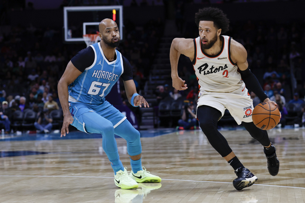 Nell Redmond Detroit Pistons guard Cade Cunningham, right, brings the ball upcourt against Charlotte Hornets forward Taj Gibson, left, during the second half of an NBA basketball game in Charlotte, N.C., Thursday, Nov. 21, 2024. (AP Photo/Nell Redmond)