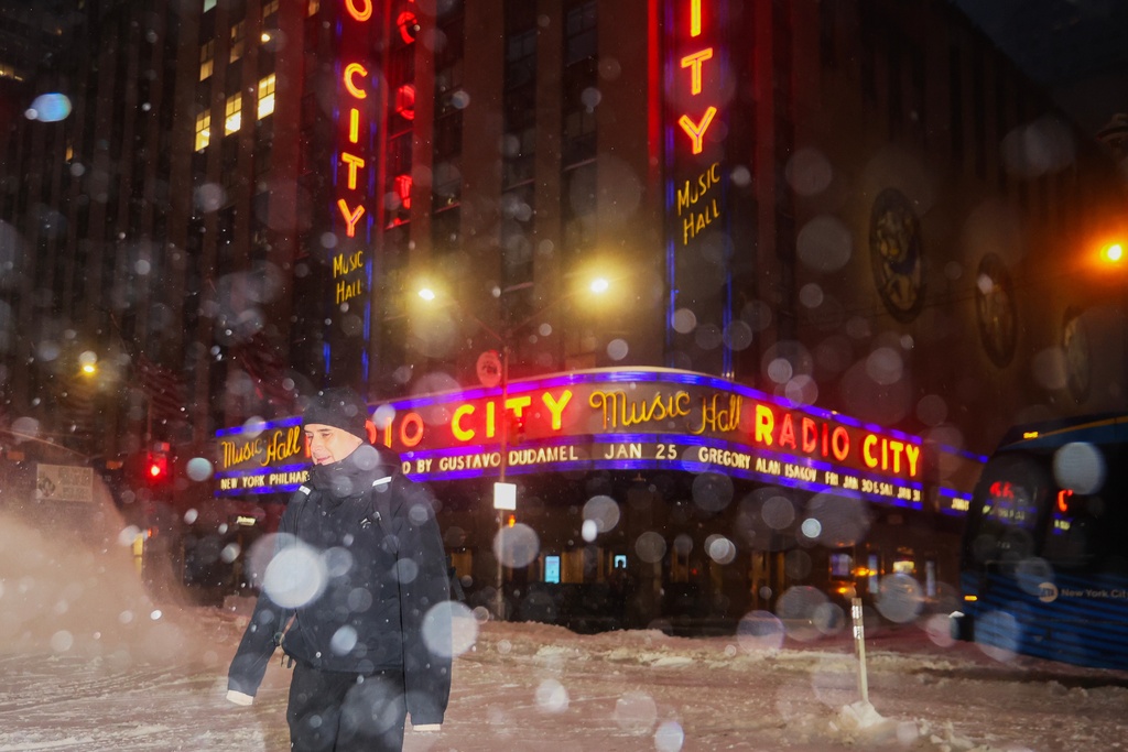 FILE - A pedestrian crosses the street near Radio City Music Hall during a winter storm Jan. 25, 2026, in New York. (AP Photo/Heather Khalifa, File)