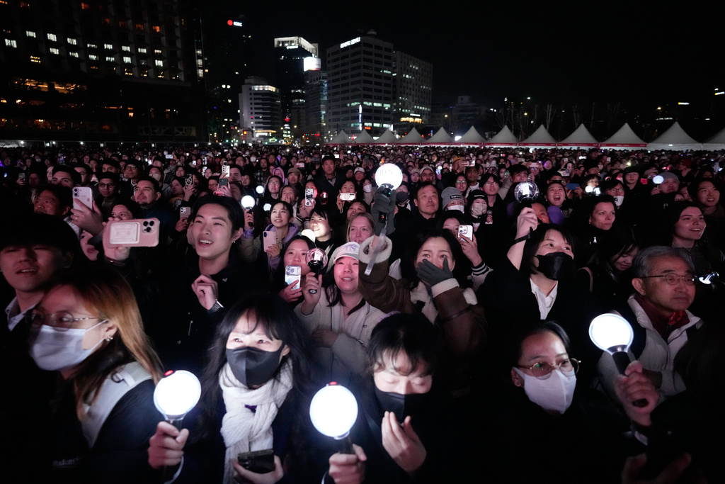 Fans react during a comeback concert of K-pop band BTS near Gwanghwamun Square in Seoul, South Korea, Saturday, March 21, 2026. (AP Photo/Ahn Young-joon)