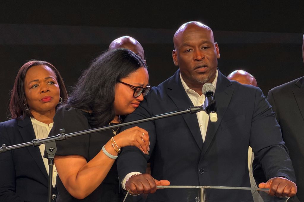 In this photo taken with a smartphone, Nolan Wells' father, Elmore Wonsley, speaks at a news conference in Stonecrest, Ga., Thursday, Sept. 22, 2026, accompanied by Wells' mother, Christine Wonsley. (AP Photo/Emilie Megnien)