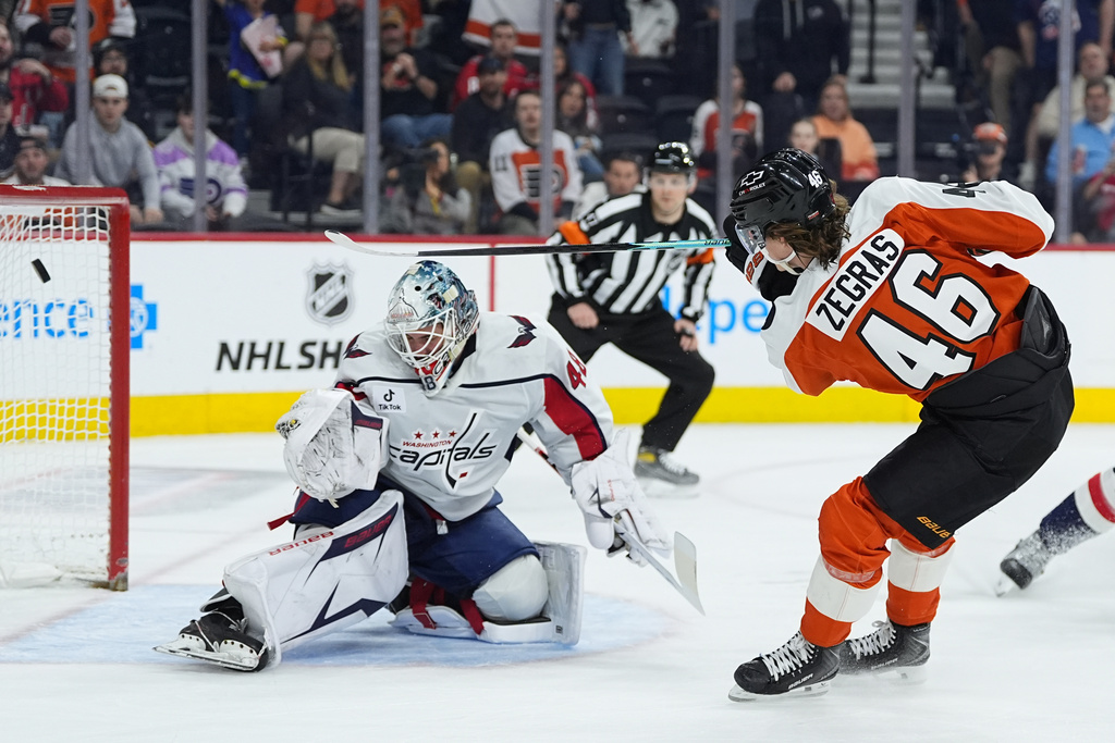 Philadelphia Flyers' Trevor Zegras (46) scores past Washington Capitals goaltender Logan Thompson during the second period of an NHL hockey game, Wednesday, March 11, 2026, in Philadelphia. (AP Photo/Matt Rourke)