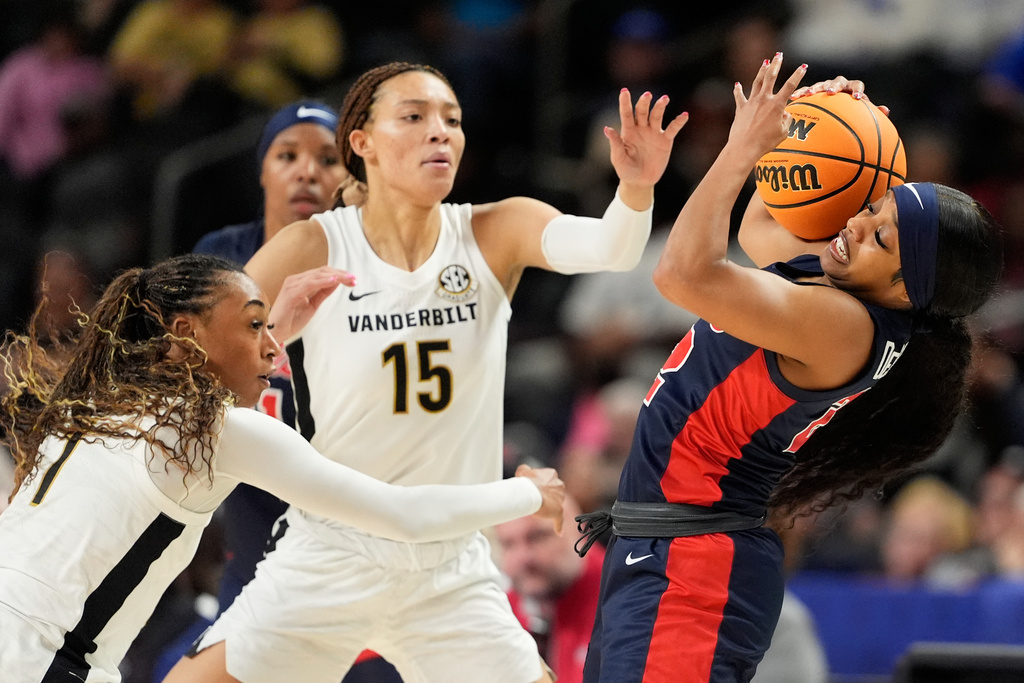 Mississippi guard Denim DeShields pulls the ball away form Vanderbilt guard Mikayla Blakes (1) and guard Ndjakalenga Mwenentanda during second half of an NCAA college basketball game in the quarterfinals of the Southeastern Conference tournament, Friday, March 6, 2026, in Greenville, S.C. (AP Photo/Chris Carlson)