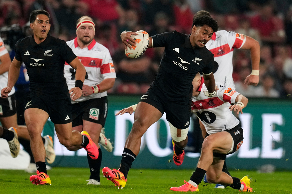 New Zealand's Emoni Narawa, front, is challenged by Lions' Nico Steyn during an international friendly rugby match between Lions and New Zealand, in Johannesburg, South Africa, Tuesday, Aug. 25, 2026. (AP Photo/Themba Hadebe)