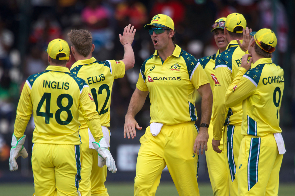 Australia's captain Mitchell Marsh, center, reacts after his teammate Nathan Ellis during the third one day international cricket match between Zimbabwe and Australia in Harare, Zimbabwe, Sunday, Sept. 20, 2026. (AP Photo/Wonder Mashura)