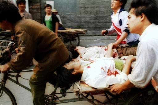 FILE - A rickshaw driver transports wounded people, with the help of bystanders, to a nearby hospital in Beijing, on Sunday, June 4, 1989, after PLA soldiers fired rounds towards crowds gathered outside Tiananmen Square. (AP Photo/Liu Heung Shing, File) FILE - A rickshaw driver transports wounded people, with the help of bystanders, to a nearby hospital in Beijing, on Sunday, June 4, 1989, after PLA soldiers fired rounds towards crowds gathered outside Tiananmen Square. (AP Photo/Liu Heung Shing, File)
