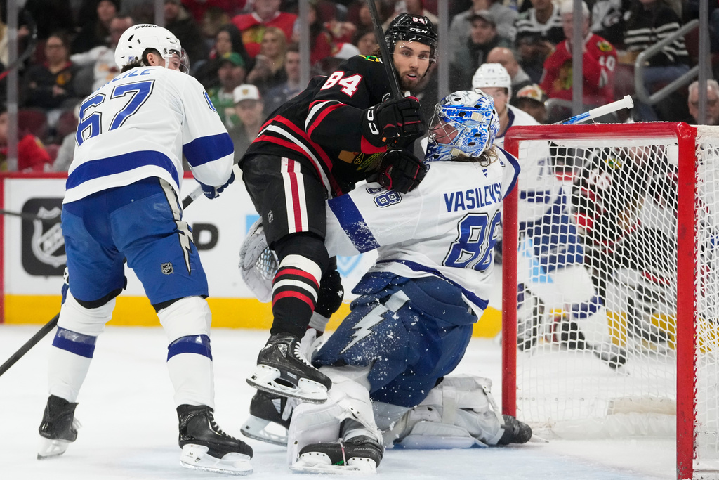 Chicago Blackhawks left wing Landon Slaggert (84) collides with Tampa Bay Lightning goaltender Andrei Vasilevskiy (88) during the second period of an NHL hockey game Friday, Jan. 23, 2026, in Chicago. (AP Photo/Erin Hooley)