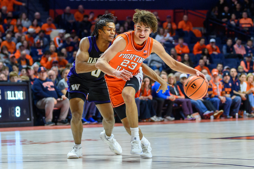 Illinois guard Keaton Wagler (23) advances the ball as Washington's Quimari Peterson defends during the first half of an NCAA college basketball game Thursday, Jan. 29, 2026, in Champaign, Ill. (AP Photo/Craig Pessman)