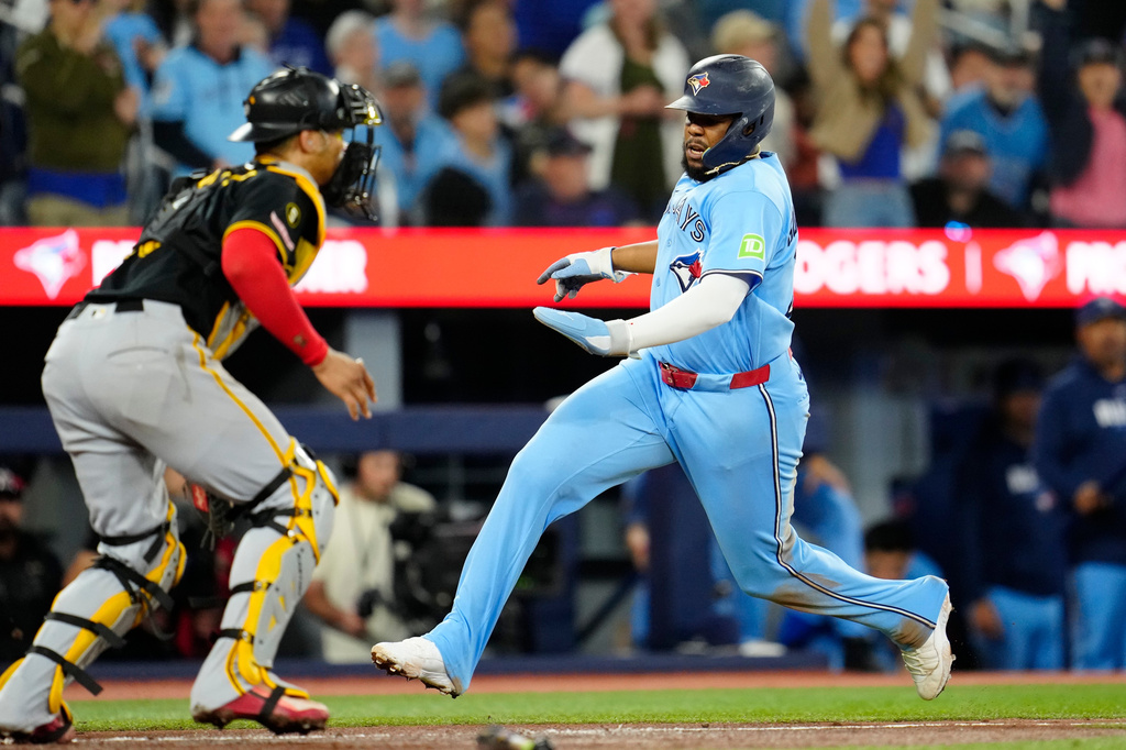 Toronto Blue Jays first baseman Vladimir Guerrero Jr. (27) scores on a Ernie Clement single during fourth inning of a baseball game against the Pittsburgh Pirates in Toronto on Sunday, May 24, 2026. (Frank Gunn /The Canadian Press via AP)