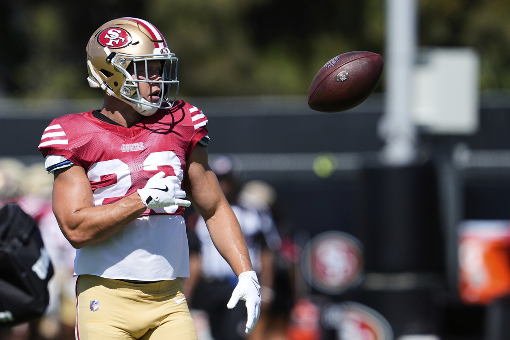 San Francisco 49ers running back Christian McCaffrey tosses the ball during a joint NFL football training camp with the Denver Broncos, Thursday, Aug. 7, 2025, in Santa Clara, Calif. (AP Photo/Godofredo A. Vásquez)
