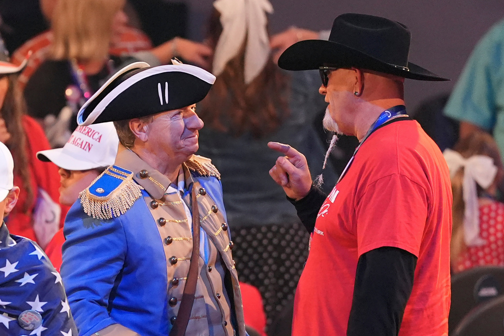 People talk after President Donald Trump spoke at a Turning Point USA event at Dream City Church, Friday, April 17, 2026, in Phoenix. (AP Photo/Ross D. Franklin)