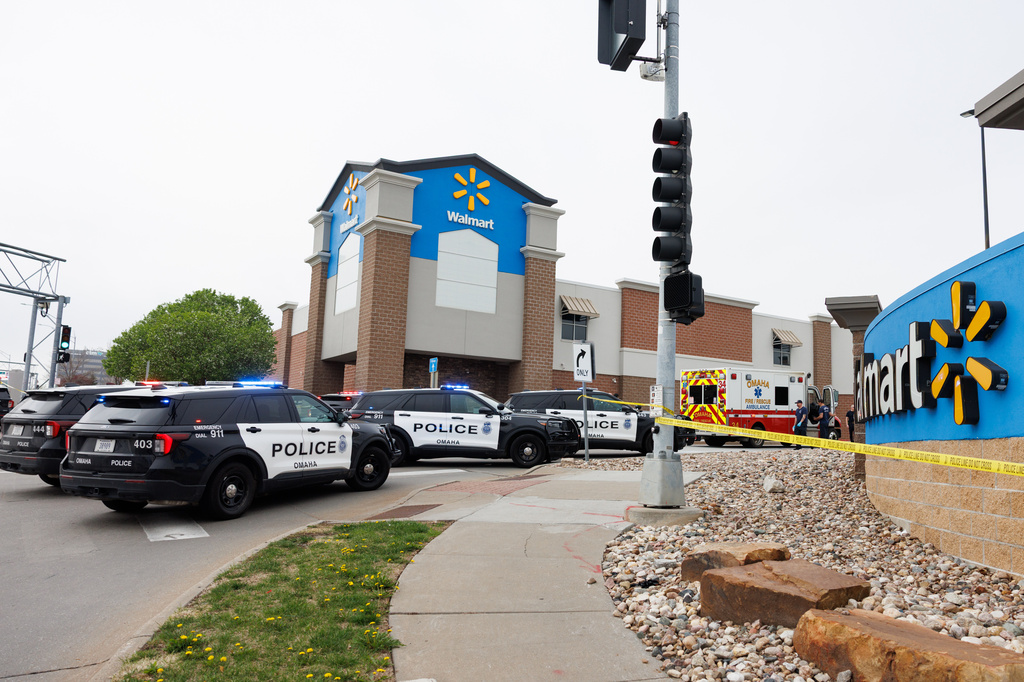 Omaha police work outside a Walmart store at South 72nd and Pine Streets in Omaha, Neb., on Tuesday, April 14, 2026, after police fatally shot a woman who was accused of cutting a young child's face with a knife. (Nikos Frazier/Omaha World-Herald via AP)