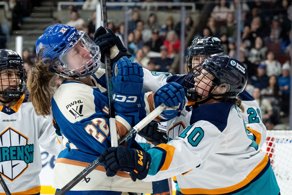New York Sirens' Sarah Fillier (10) hits Vancouver Goldeneyes' Abby Boreen (22) during the third period of a PWHL hockey game in Vancouver, British Columbia, Wednesday, March 18, 2026. (Ethan Cairns/The Canadian Press via AP)