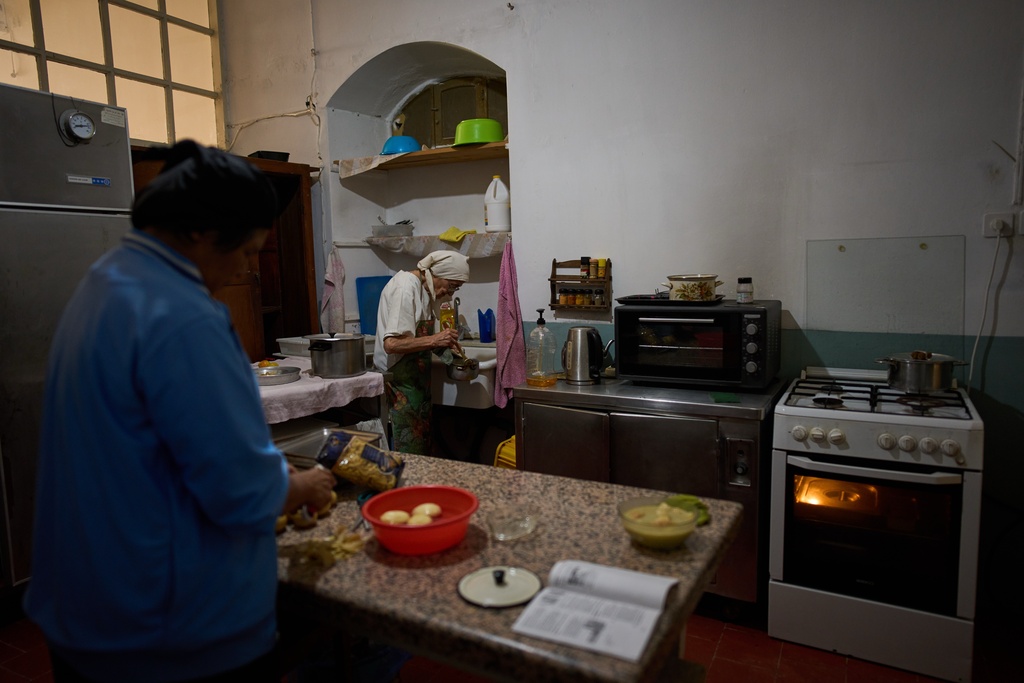 Lunch is prepared at the Benedictine monastery on top of the Mount of Olives during the olive harvest there, in Jerusalem, on Friday, Oct. 17, 2025. (AP Photo/Oded Balilty)