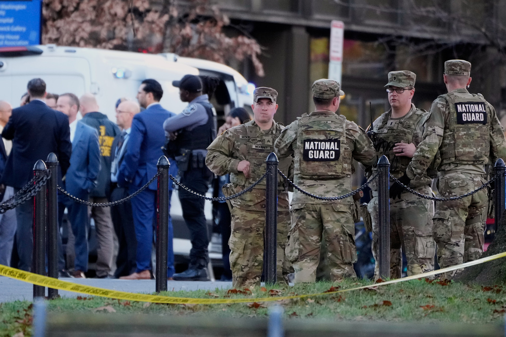 Emergency personnel gather in a cordoned off area where National Guard soldiers were shot near the White House Wednesday, Nov. 26, 2025, in Washington. (AP Photo/Mark Schiefelbein)