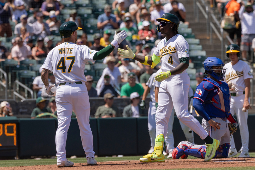 Athletics' Lawrence Butler (4) celebrates with Tommy White (47) after hitting a two-run home run during the second inning of a baseball game against the Texas Rangers, Sunday, Aug. 16, 2026, in West Sacramento, Calif. (AP Photo/Sara Nevis)