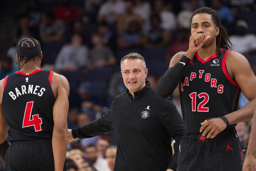 Toronto Raptors head coach Darko Rajakovic, center, reacts as he gives a rest to forward Scottie Barnes (4) as forward Collin Murray-Boyles (12) enters an NBA basketball game during the first half against the Memphis Grizzlies, Friday, April 3, 2026, in Memphis, Tenn. (AP Photo/Nikki Boertman)