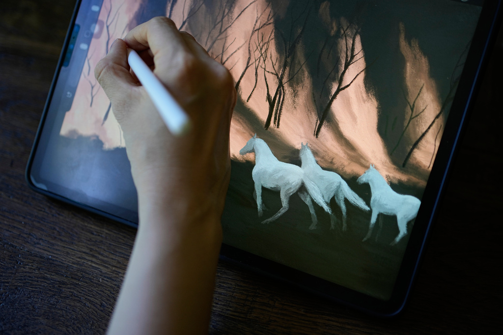 Illustrator Marina Antonova works on a drawing for her series called "Chronicles of a Heating Planet" in Beaumont-les-Valence, southern France, on Sept. 12, 2026. (AP Photo/Laurent Cipriani)