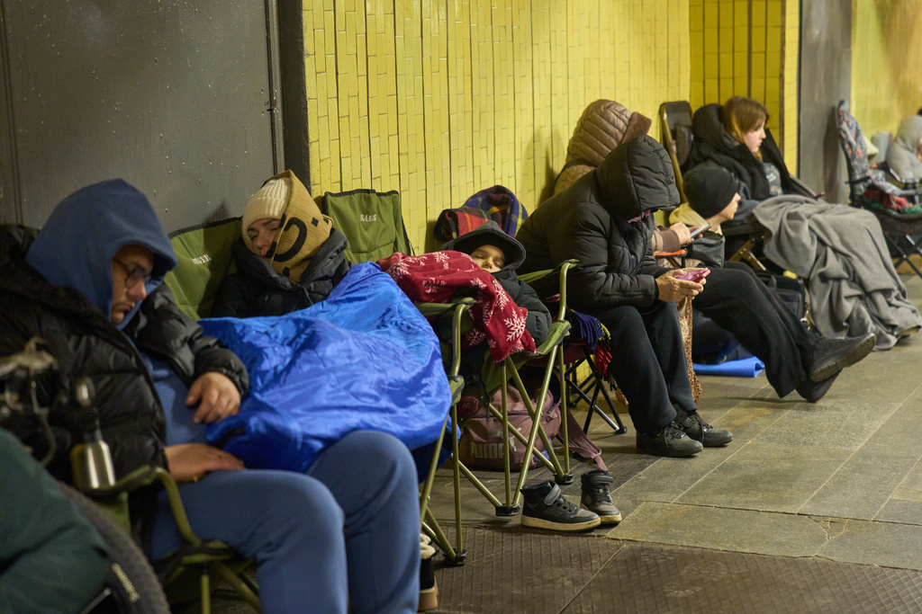 People hide in an underground pedestrian crossing during Russia's night missile and drone attack in Kyiv, Ukraine, Saturday, Nov. 29, 2025. (AP Photo/Efrem Lukatsky)