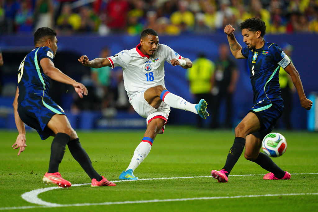 Haiti's Wilson Isidor (18) kicks the ball past Brazil's Casemiro (5) and Brazil's Marquinhos (4) during the World Cup Group C soccer match between Brazil and Haiti in Philadelphia, Friday, June 19, 2026. (AP Photo/Derik Hamilton)