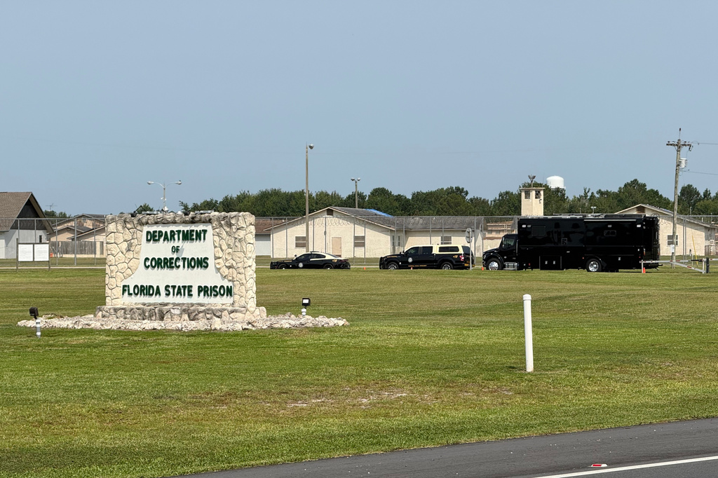 FILE - Law enforcement vehicles sit parked outside the Florida state prison in Starke, Fla., on Tuesday, July 28, 2026. (AP Photo/David Fischer, file)