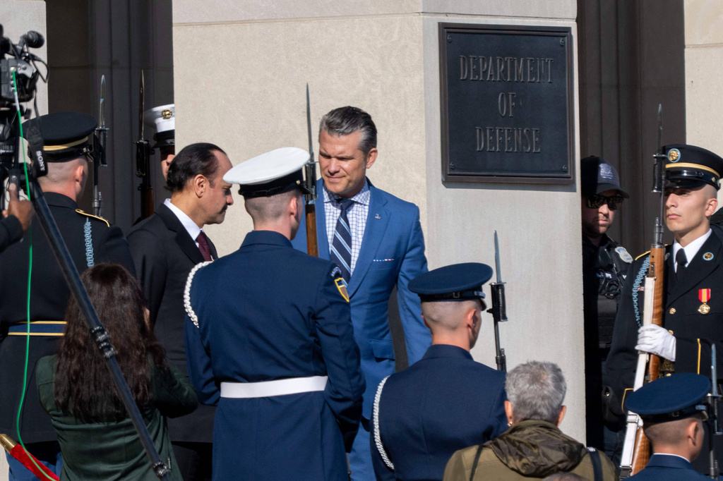 Defense Secretary Pete Hegseth, center, welcomes Qatar Minister of Defense Sheikh Saoud Al Thani to the Pentagon, Friday, Oct. 10, 2025 in Washington. (AP Photo/Kevin Wolf)