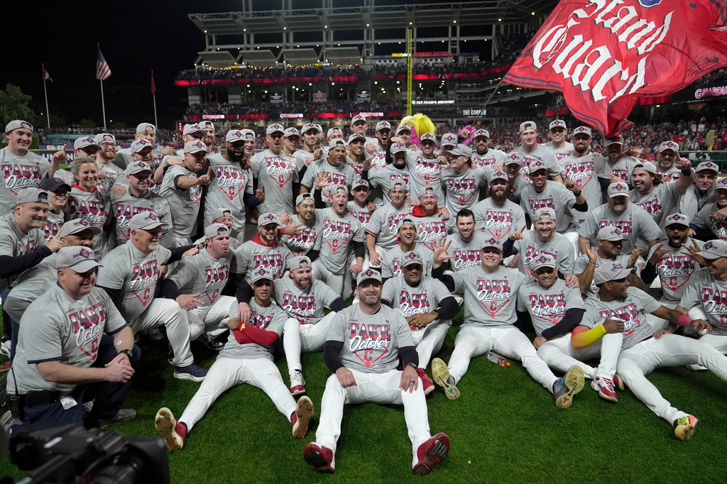 Cleveland Guardians players and coaches celebrate after Game 5 of baseball's American League Division Series against the Chicago White Sox, Saturday, Oct. 10, 2026, in Cleveland. (AP Photo/Sue Ogrocki)