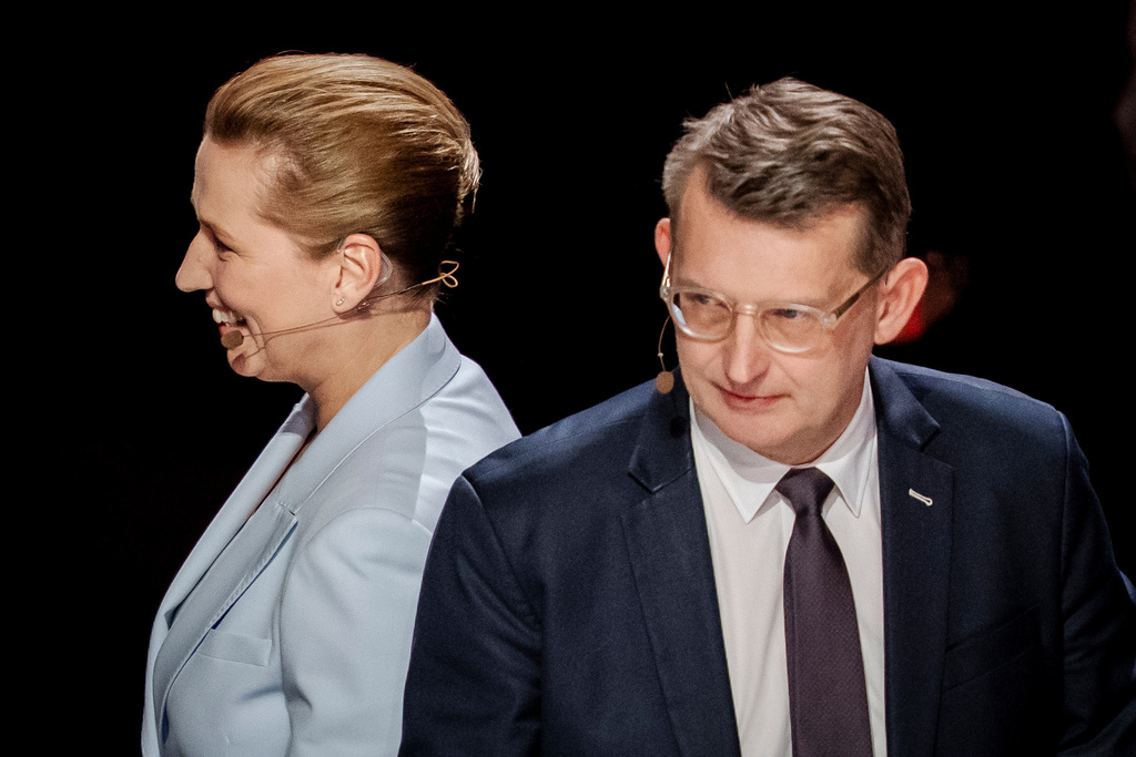 Denmark's Prime Minister Mette Frederiksen, left, and Defense Minister Troels Lund Poulsen, right, attend the party leader debate Democracy's Evening on DR1 at the Concert Hall, DR City in Copenhagen, Sunday, March 22, 2026. (Mads Claus Rasmussen/Ritzau Scanpix via AP)