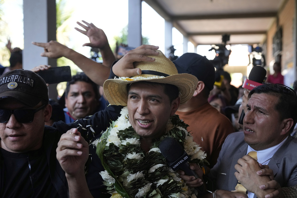 Presidential candidate Andronico Rodriguez leaves a polling station after voting as opponents throw stones in Entre Rios, in the Chapare region of Bolivia, Sunday, Aug. 17, 2025. (AP Photo/Jorge Saenz)