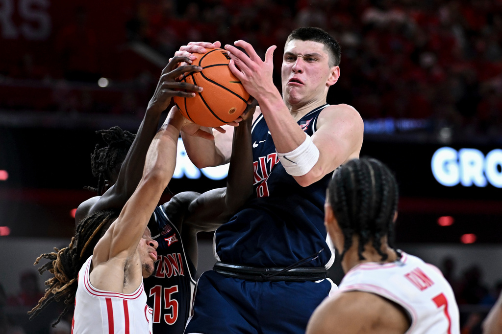 Arizona forward Ivan Kharchenkov, top, attempts to secure a rebound during the first half of an NCAA college basketball game against Houston, Saturday, Feb. 21, 2026, in Houston. (AP Photo/Maria Lysaker)