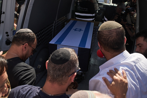 Relatives mourn over the coffin of slain hostage Yossi Sharabi during his funeral procession in Rishon LeZion, Israel, Monday, Oct. 27, 2025. Sharabi remains were returned from Gaza to Israel as part of a ceasefire agreement between Israel and Hamas.(AP Photo/Leo Correa) Relatives mourn over the coffin of slain hostage Yossi Sharabi during his funeral procession in Rishon LeZion, Israel, Monday, Oct. 27, 2025. Sharabi remains were returned from Gaza to Israel as part of a ceasefire agreement between Israel and Hamas.(AP Photo/Leo Correa)