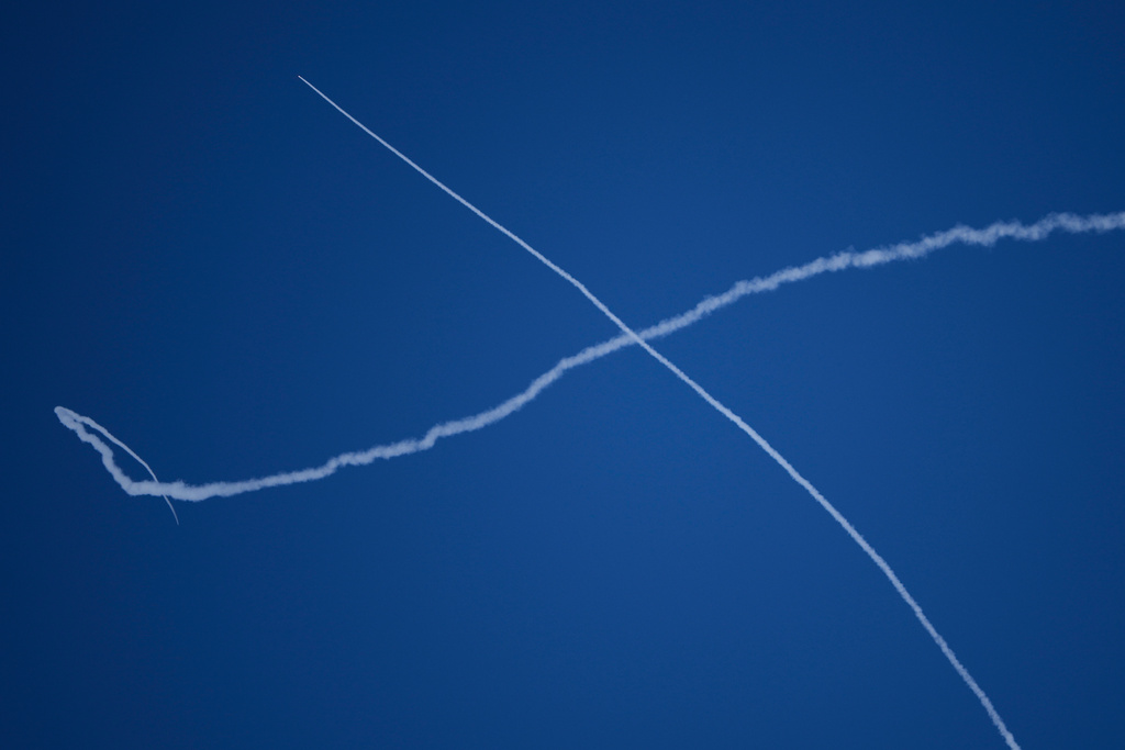 Israeli air defense system fires to intercept missiles during an Iranian attack over central Israel, Sunday, March 1, 2026. (AP Photo/Ohad Zwigenberg)