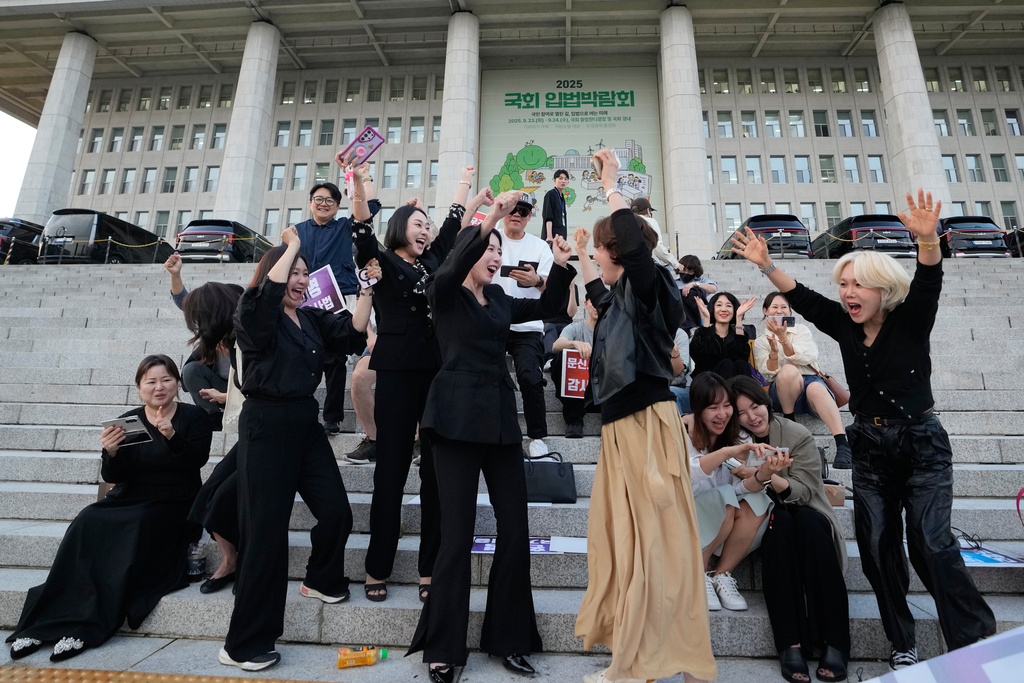 Members of the Korea Tattoo Federation celebrate after hearing the news that parliament passed a bill that would allow non-medical personnel to give tattoos outside the National Assembly, in Seoul, South Korea, Thursday, Sept. 25, 2025. (AP Photo/Ahn Young-joon)