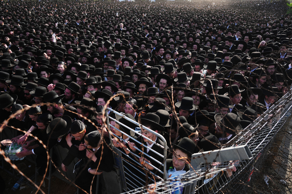 Ultra-Orthodox Jewish men protest against military recruitment and call for the release of detained draft resisters outside a military prison near Kfar Yona, Israel, Wednesday, June 17, 2026. (AP Photo/Ariel Schalit)