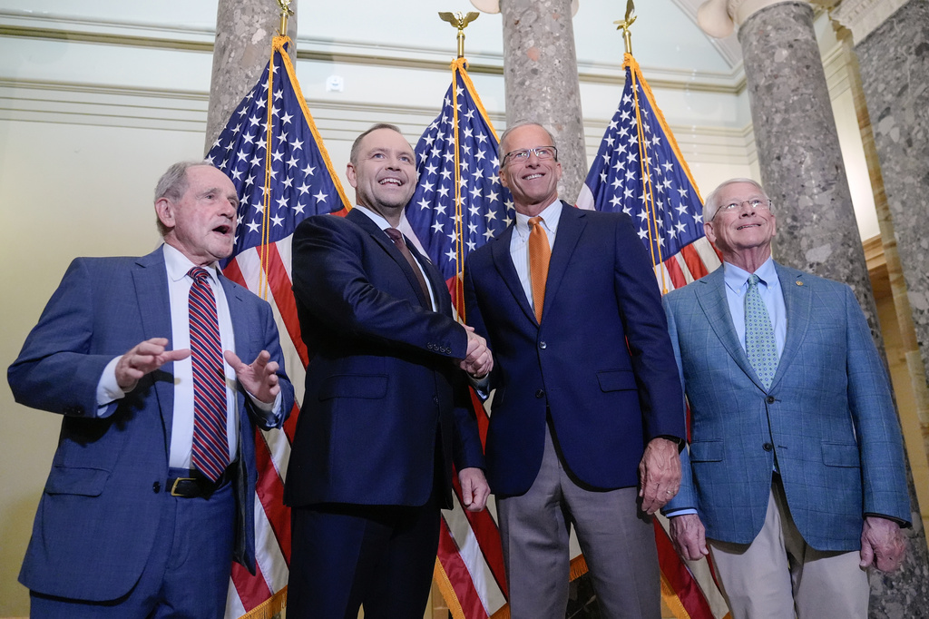 Poland's President Karol Nawrocki, center, shakes hand with Sen. Majority Leader John Thune, R-S.D., as Sen. Jim Risch, R-Idaho, left, Sen. Roger Wicker, R-Miss., right, stand for a group photo before a meeting on Capitol Hill, Monday, June 15, 2026, in Washington. (AP Photo/Mariam Zuhaib)