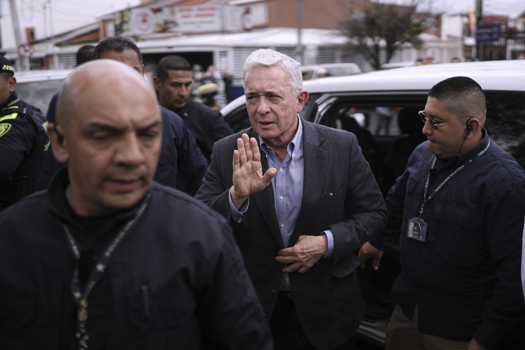 Former Colombian President Alvaro Uribe visits the site where presidential hopeful and Sen. Miguel Uribe Turbay was fatally shot during a political rally in Bogota, Colombia, Saturday, Aug. 23, 2025. (AP Photo/Ivan Valencia)