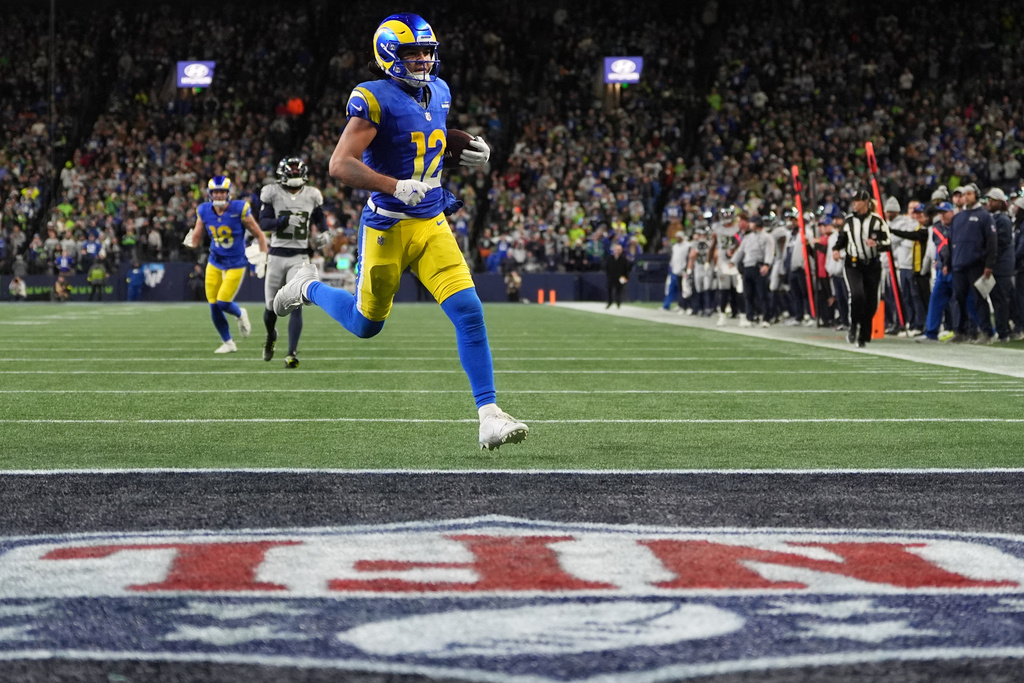 Los Angeles Rams wide receiver Puka Nacua scores a touchdown during overtime in an NFL football game against the Seattle Seahawks, Thursday, Dec. 18, 2025, in Seattle. (AP Photo/Lindsey Wasson)