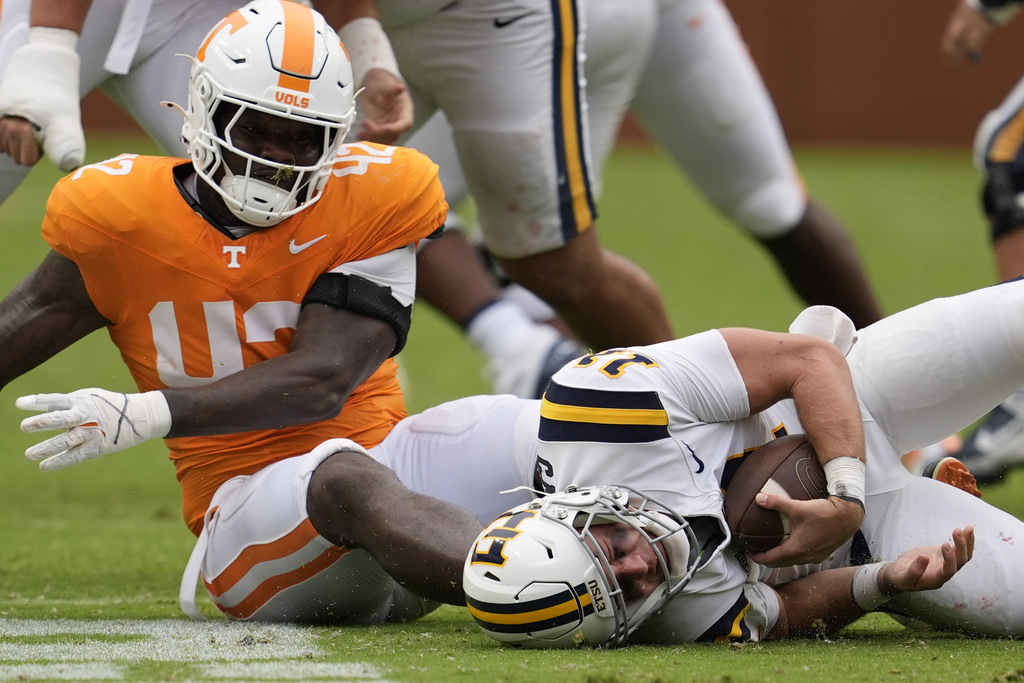 Tennessee defensive lineman Tyre West (42) sacks East Tennessee State quarterback Cade McNamara (11) during the second half of an NCAA college football game Saturday, Sept. 6, 2025, in Knoxville, Tenn. (AP Photo/George Walker IV)