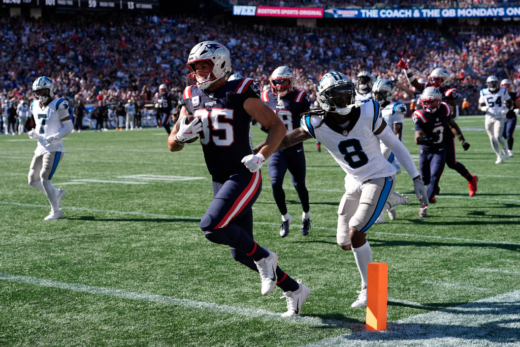 New England Patriots tight end Hunter Henry (85) runs against Carolina Panthers cornerback Jaycee Horn (8) to score a touchdown during the second half of an NFL football game, Sunday, Sept. 28, 2025, in Foxborough, Mass. (AP Photo/Charles Krupa)