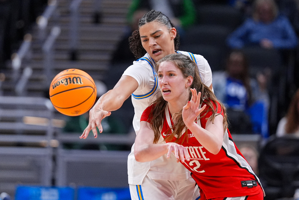 UCLA center Lauren Betts (51) defends Ohio State center Elsa Lemmila (12) in the second half of an NCAA college basketball game in the semifinals of the Big Ten Conference tournament, Saturday, March 7, 2026 in Indianapolis. (AP Photo/Michael Conroy)
