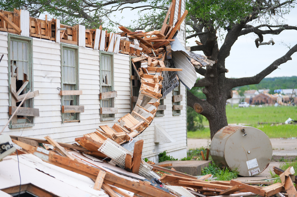 A damaged home is surrounded by debris following a storm in Mineral Wells, Texas, Wednesday, April 29, 2026. (AP Photo/Julio Cortez)