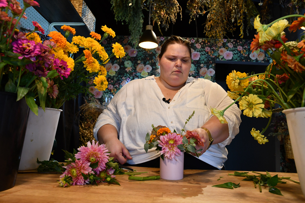 Marisa Mender-Franklin arranges a bouquet on Thursday, July 23, 2026, in her florist shop, Midtown Bramble & Bloom, in Memphis, Tenn. (AP Photo/Kristin M. Hall)
