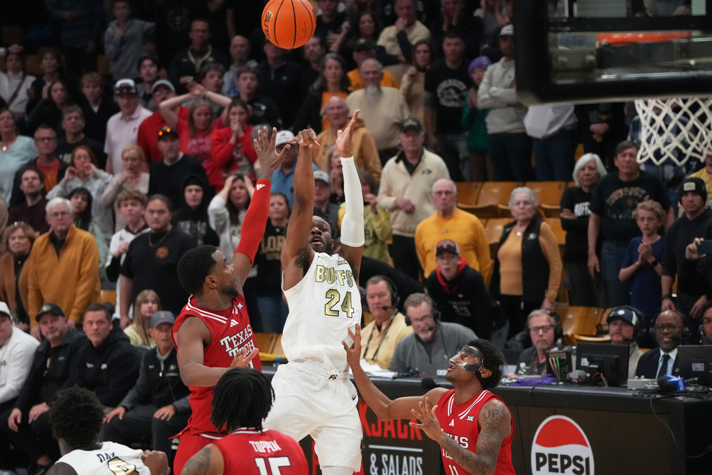 Colorado guard Barrington Hargress, center, shoots a last-second, 3-point basket between Texas Tech forward Donovan Atwell, left, and guard Jaylen Petty in the second half of an NCAA college basketball game, Saturday, Jan. 10, 2026, in Boulder, Colo. (AP Photo/David Zalubowski)