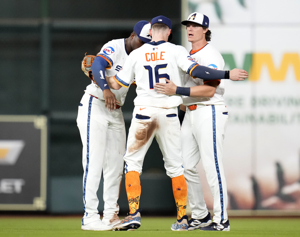 Houston Astros right fielder Jesus Sanchez, left, right fielder Zachary Cole (16), and center fielder Jake Meyers, right, celebrate after their win over the Texas Rangers in a baseball game Monday, Sept. 15, 2025, in Houston. (AP Photo/Karen Warren)
