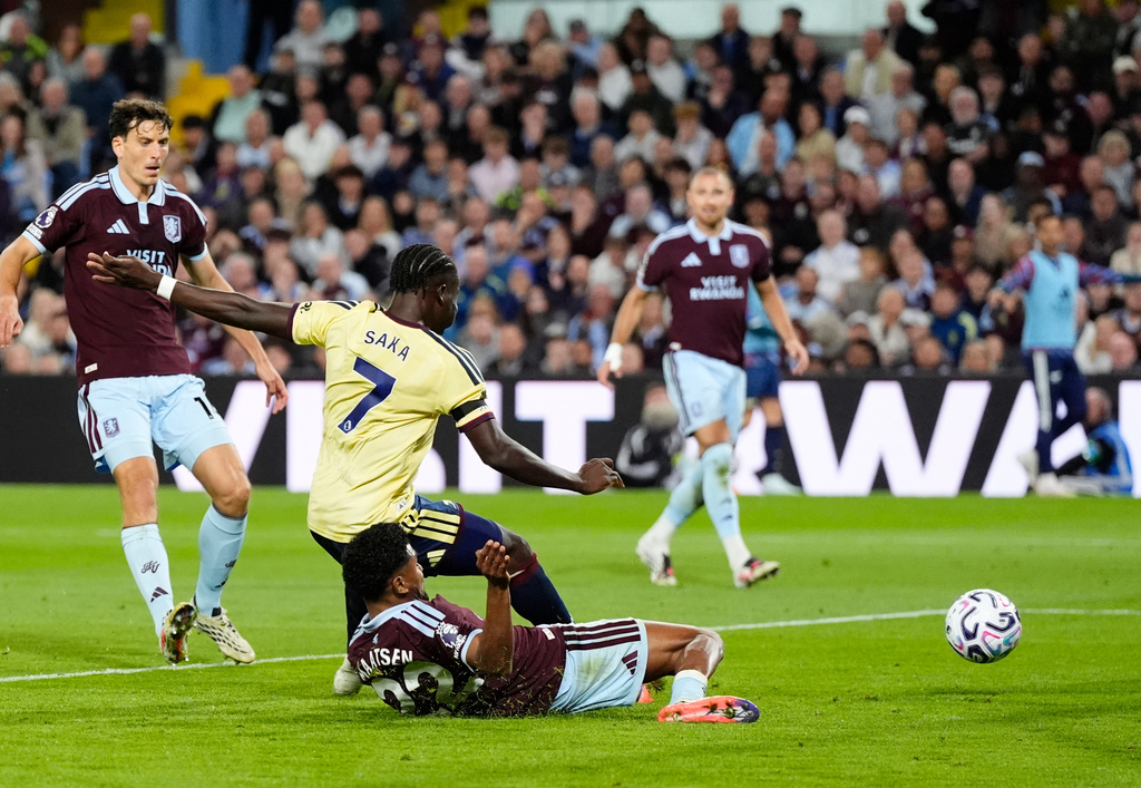 Arsenal's Bukayo Saka (7) scores his side's opening goal during the English Premier League soccer match between Aston Villa and Arsenal in Birmingham, England, Monday, Aug. 31, 2026. (Nick Potts/PA via AP)